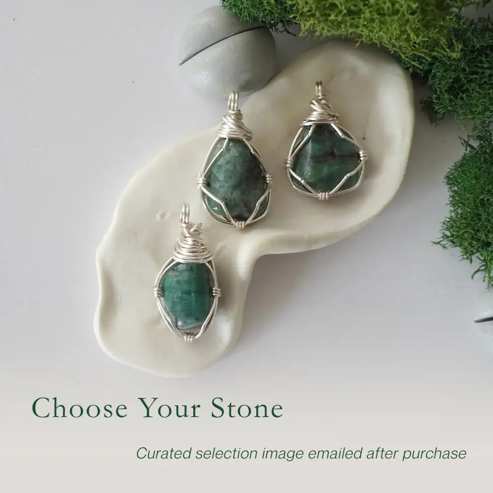 Three different raw emerald pendants displayed for variation reference