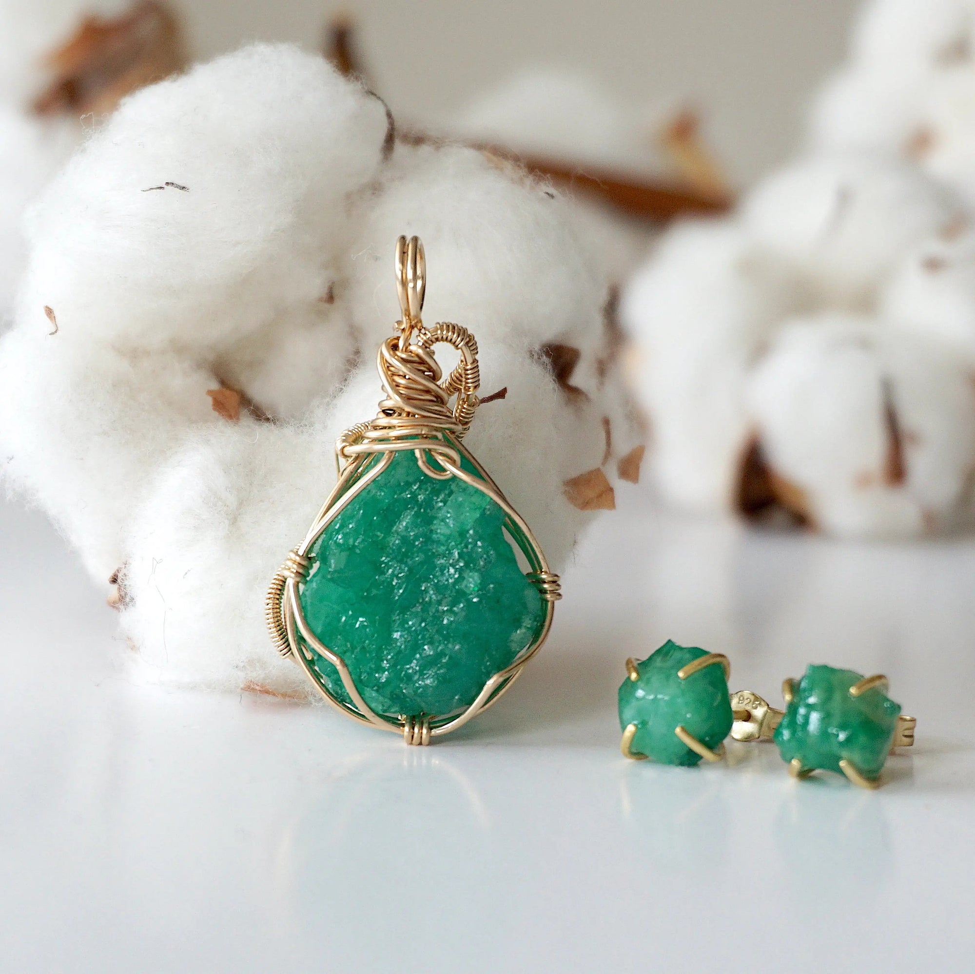 Detailed back view of raw emerald stud earrings in 14k gold filled. One of a kind May birthstone earrings by Designs by Nature Gems.