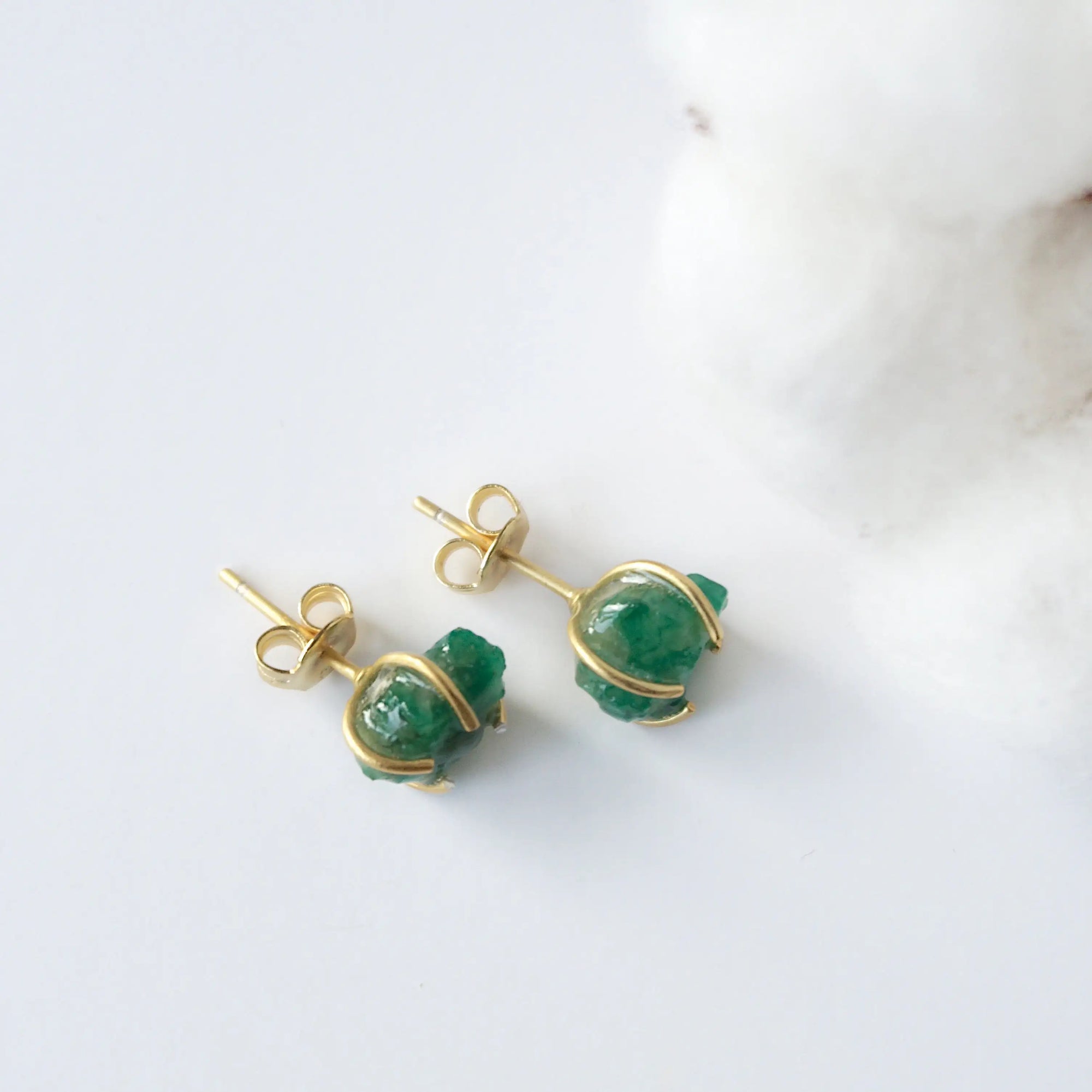 Back view of raw emerald stud earrings in 14k gold vermeil showing artisan setting and earring post detail