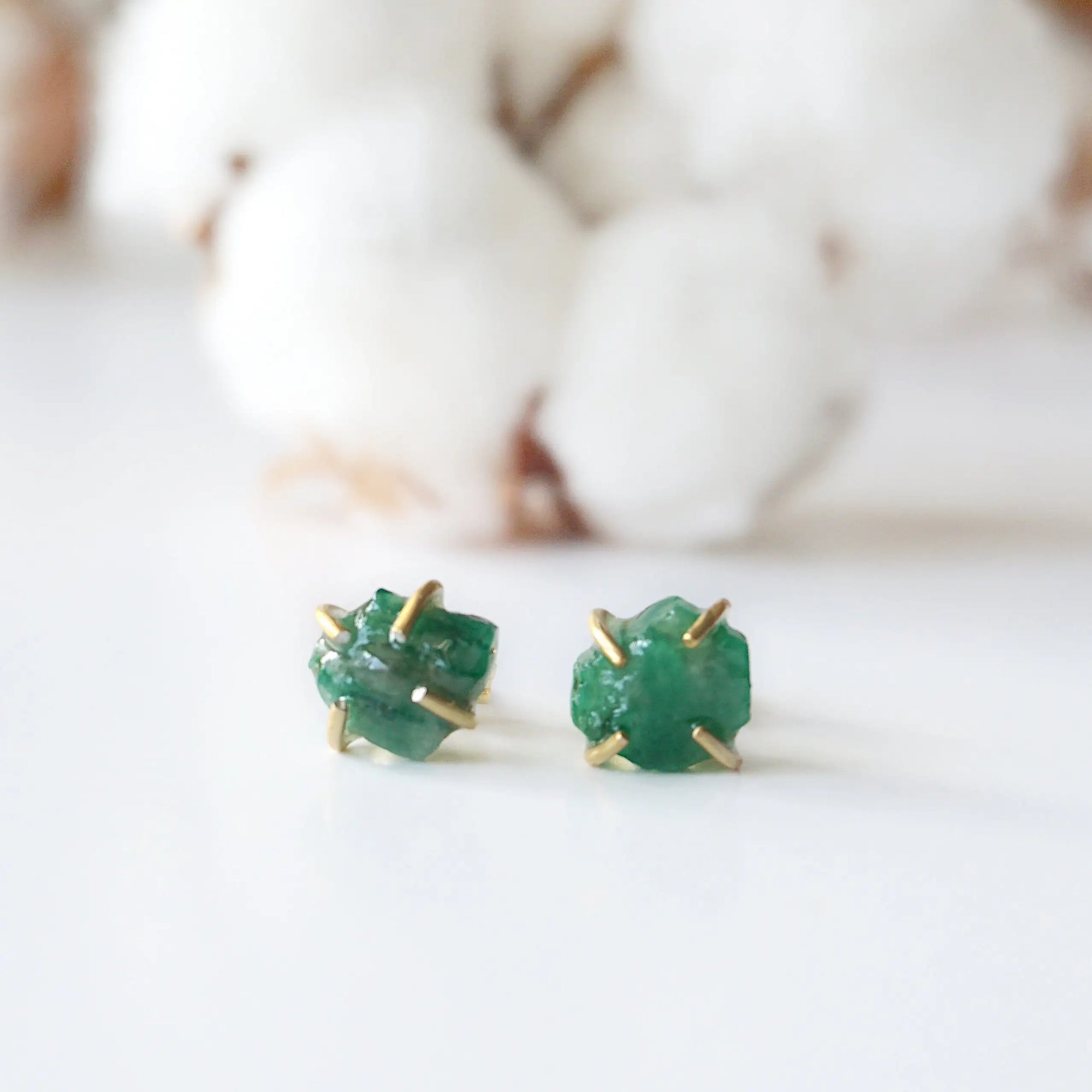 Front view of raw emerald stud earrings in 14k gold vermeil with natural emerald stones and handcrafted prong setting