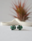 Front view of raw emerald stud earrings in sterling silver with natural emerald stones and handcrafted prong setting