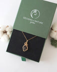 Raw garnet necklace in 14k gold filled displayed in branded Designs by Nature Gems jewelry box. Artisan January birthstone gift for women.