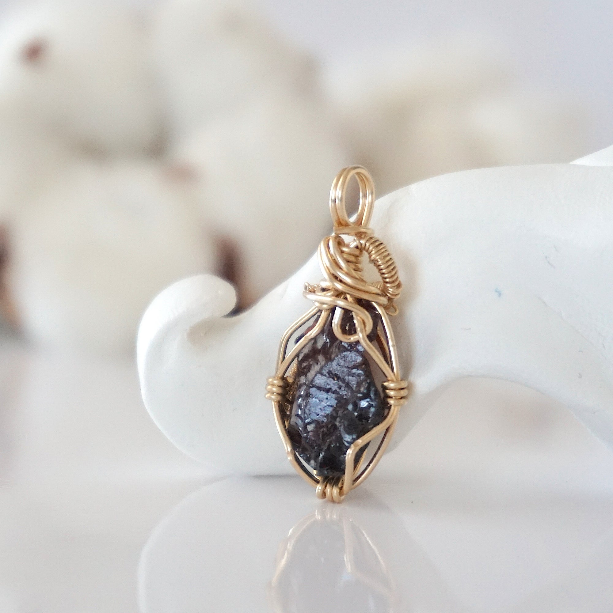 Back view of raw garnet pendant in 14k gold filled, highlighting stone and wire detail. One of a kind January birthstone jewelry by Designs by Nature Gems.