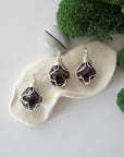 Three different raw garnet pendants displayed for variation reference