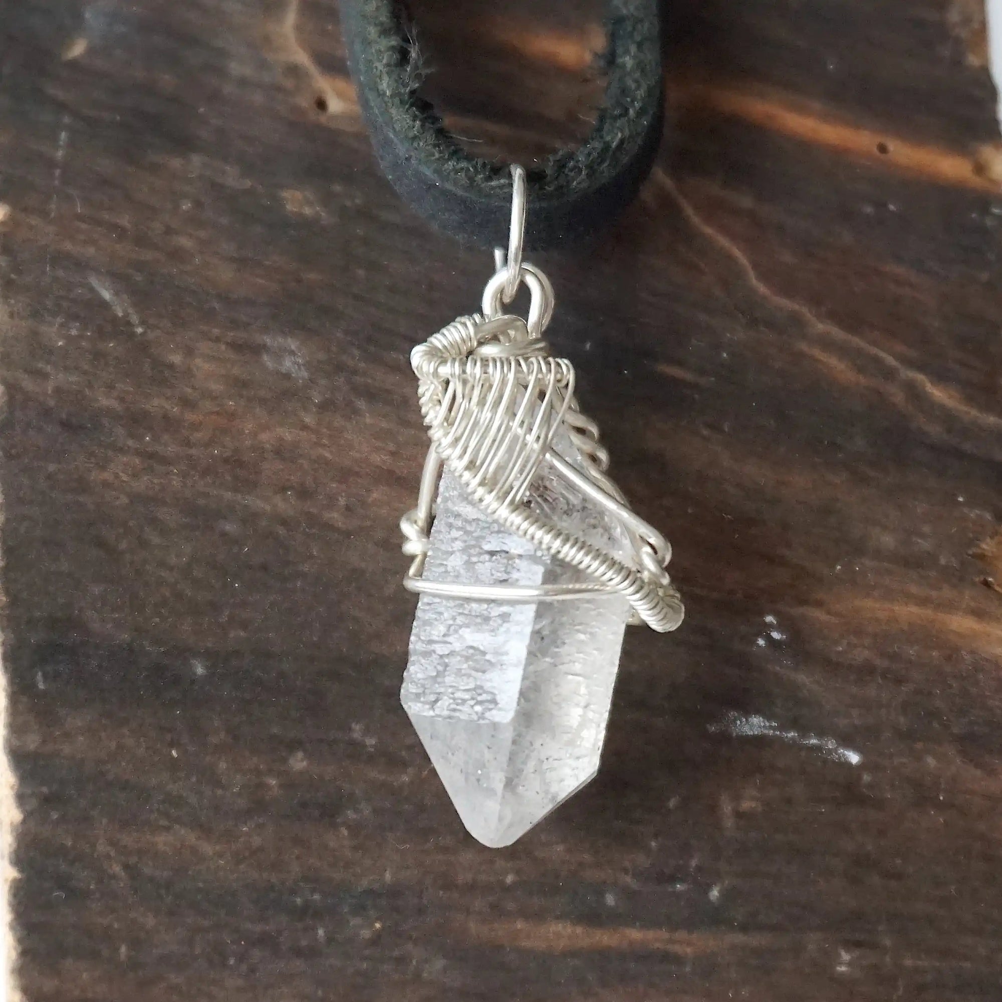 Detailed view of raw Herkimer diamond necklace for men with artisan wire wrapping in 925 sterling silver.