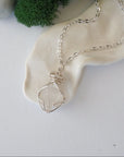 Detailed view of raw Herkimer diamond necklace with artisan wire wrapping in soft silver copper for women.