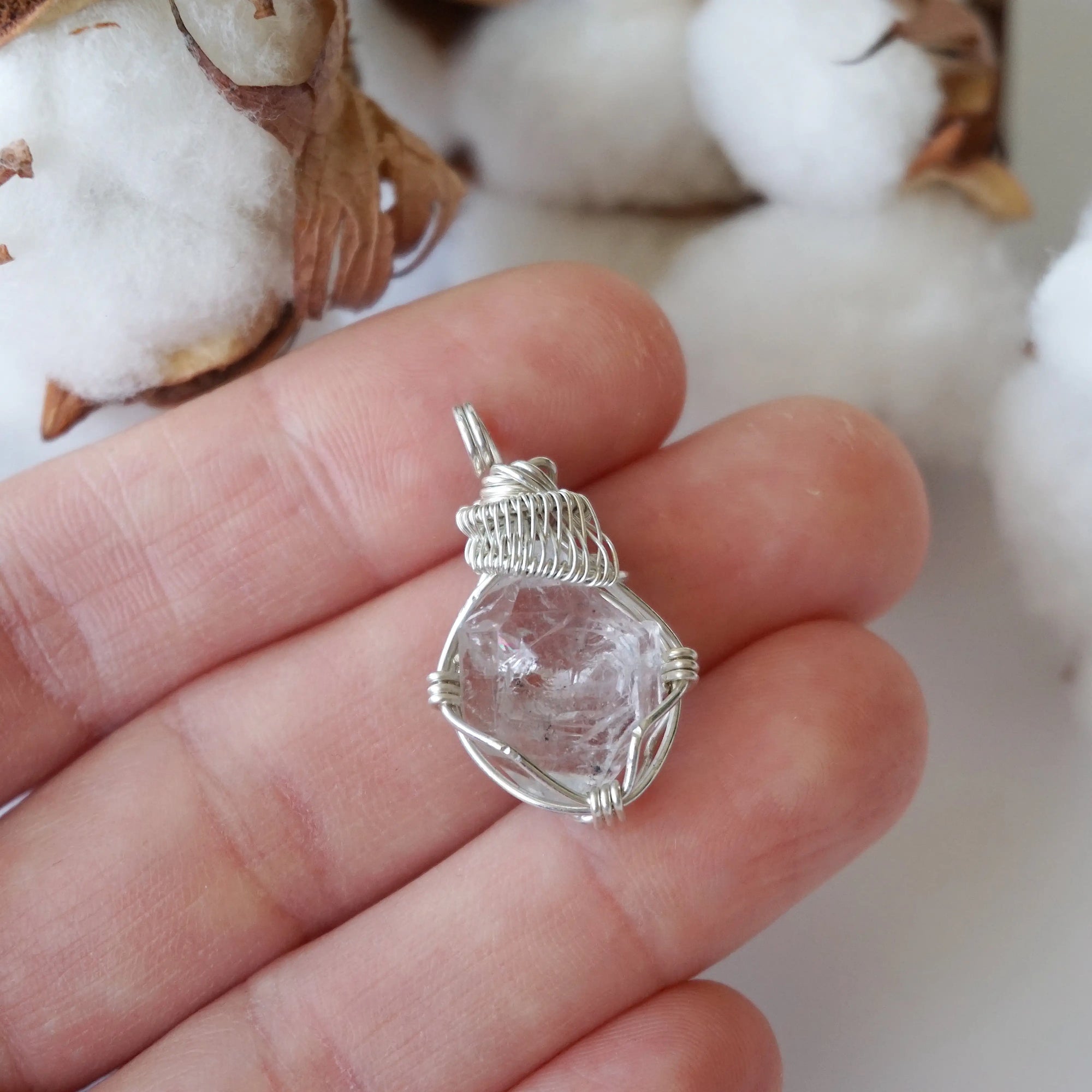 Raw Herkimer diamond necklace for women shown in hand for size reference with artisan wire wrapping in 925 sterling silver.