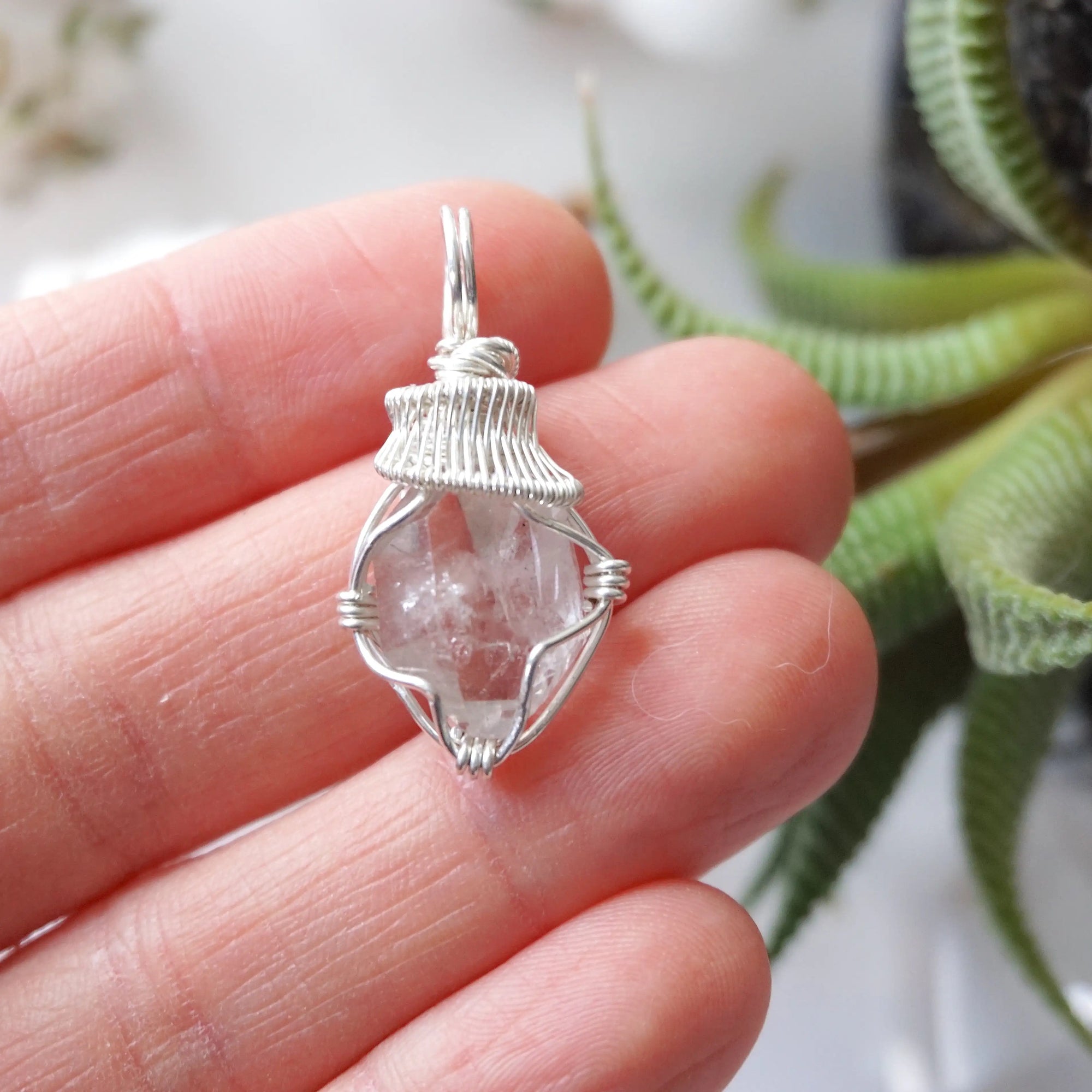 Raw Herkimer diamond necklace for women shown in hand for size reference with artisan wire wrapping in 925 sterling silver.