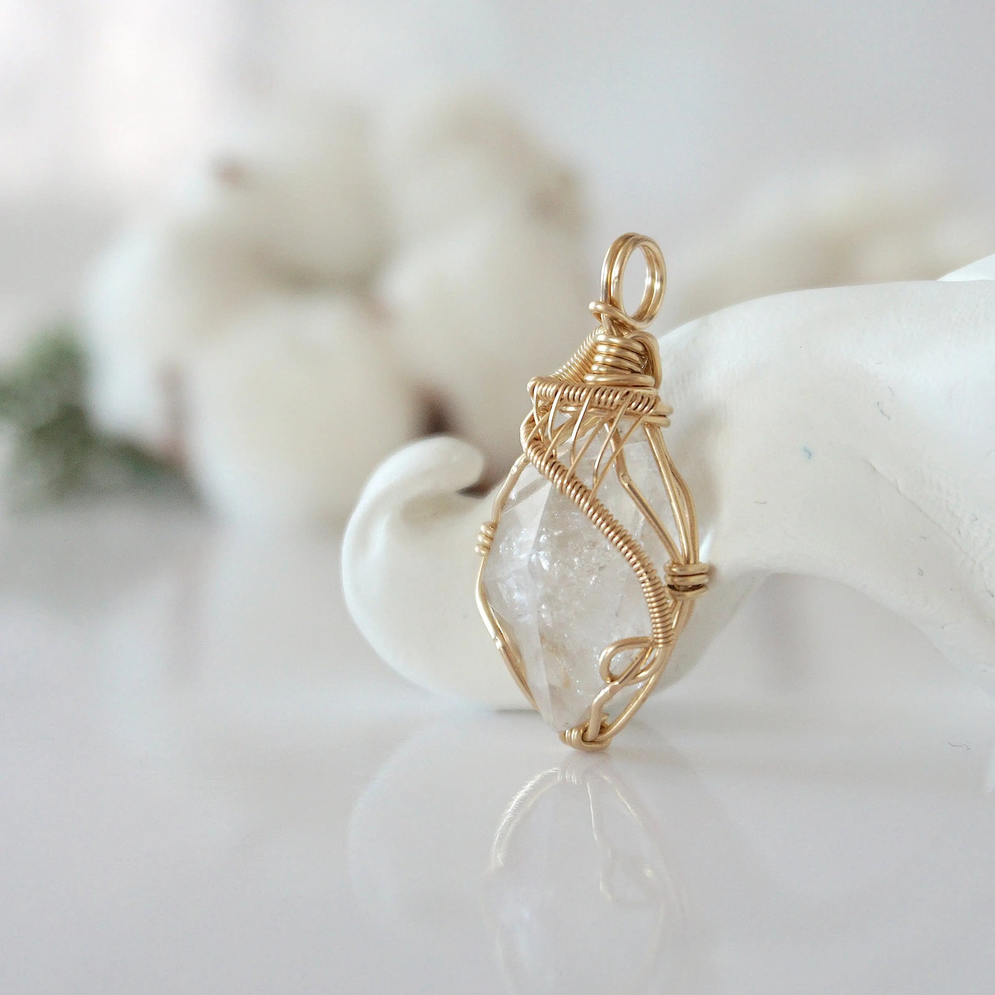 Side view of raw Herkimer diamond pendant in 14k gold filled, showing artisan wire wrapping. Handcrafted April birthstone necklace by Designs by Nature Gems.