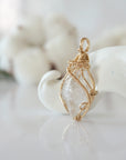 Side view of raw Herkimer diamond pendant in 14k gold filled, showing artisan wire wrapping. Handcrafted April birthstone necklace by Designs by Nature Gems.
