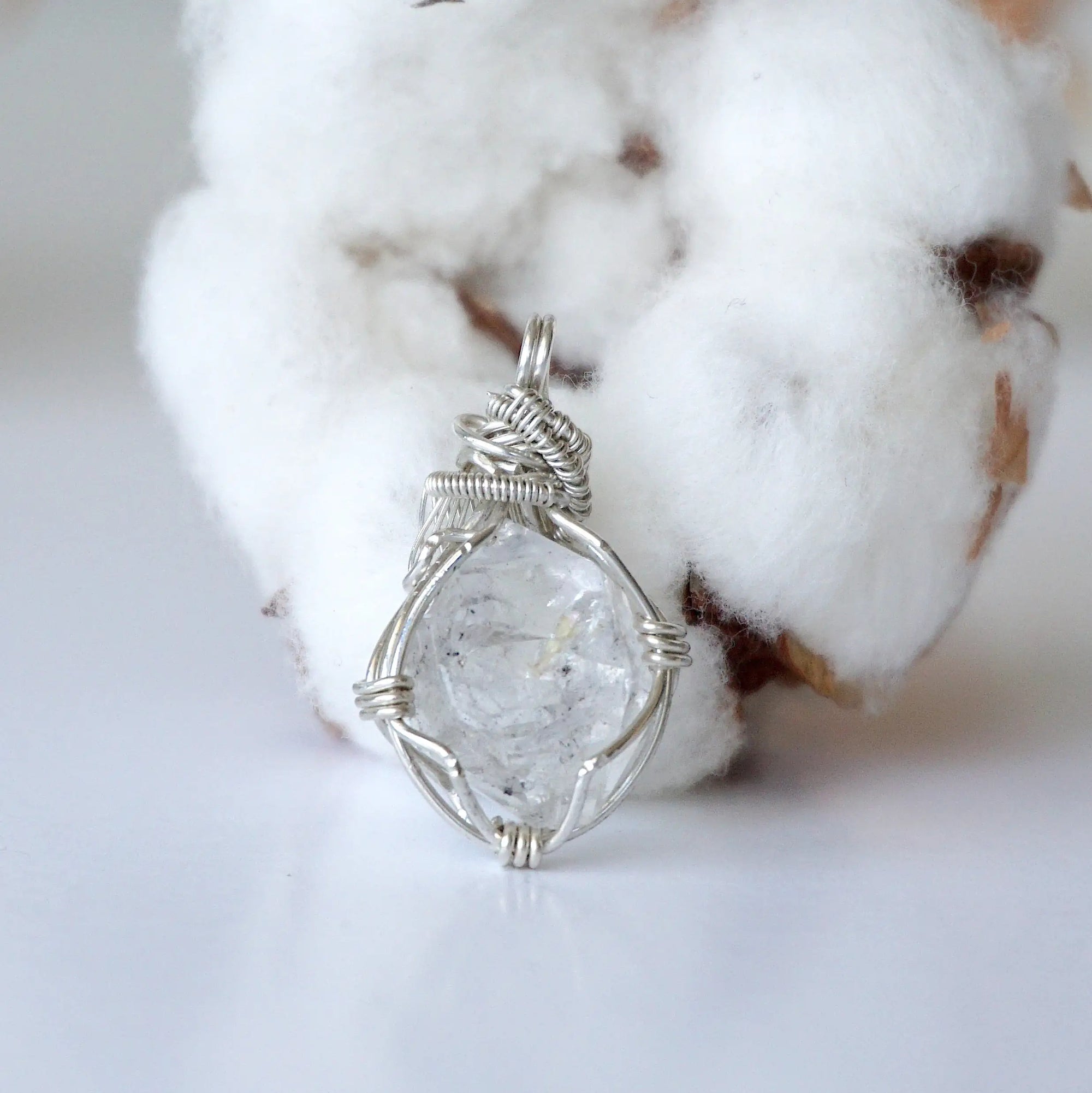 Back view of raw Herkimer diamond pendant for women with handcrafted 925 sterling silver wire wrapping.