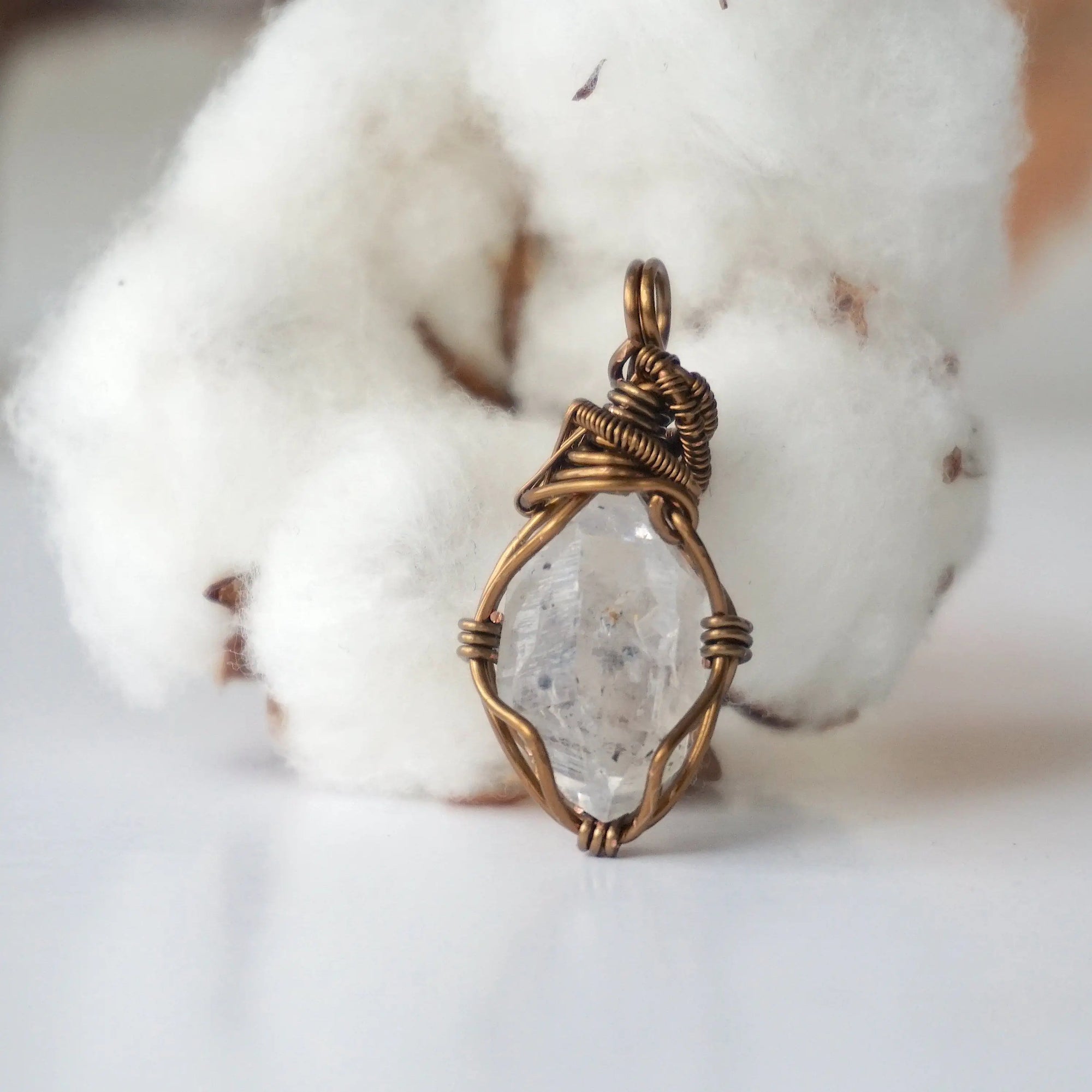 Back view of raw Herkimer diamond pendant for women with handcrafted antique bronze copper wire wrapping.