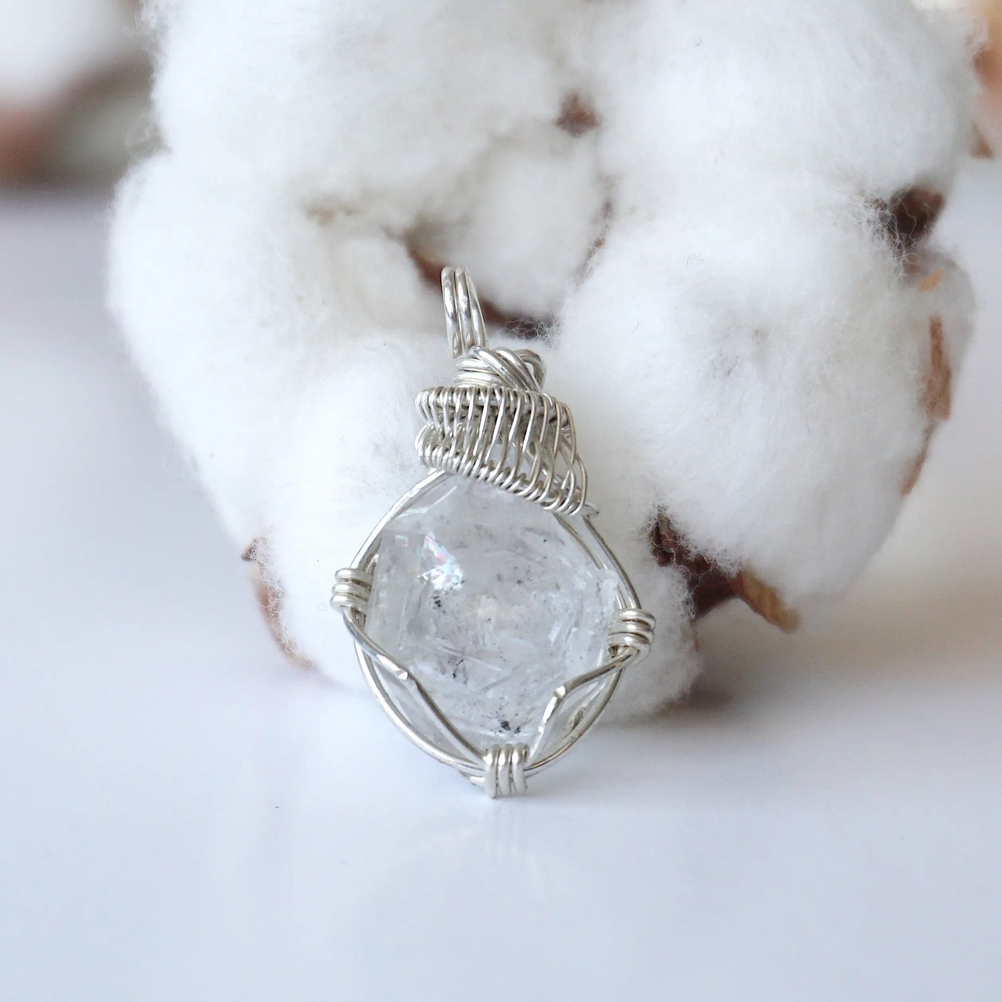 Front view of raw Herkimer diamond pendant for women with detailed artisan wire wrapping in 925 sterling silver.