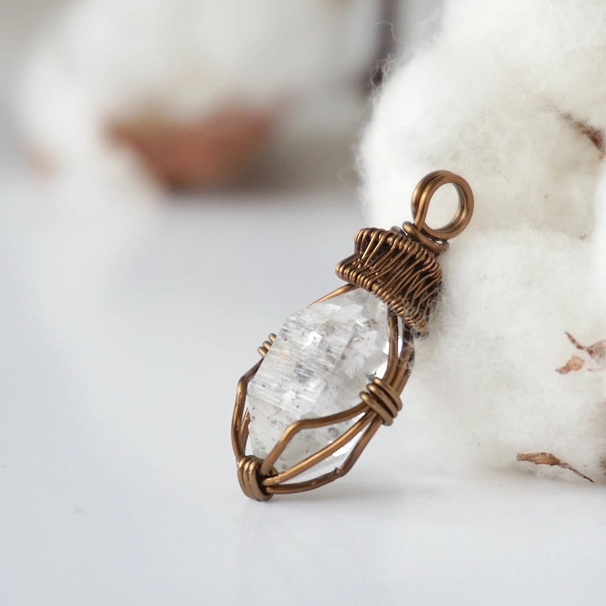Left angle view of raw Herkimer diamond necklace for women highlighting artisan wire wrapping in antique bronze copper.
