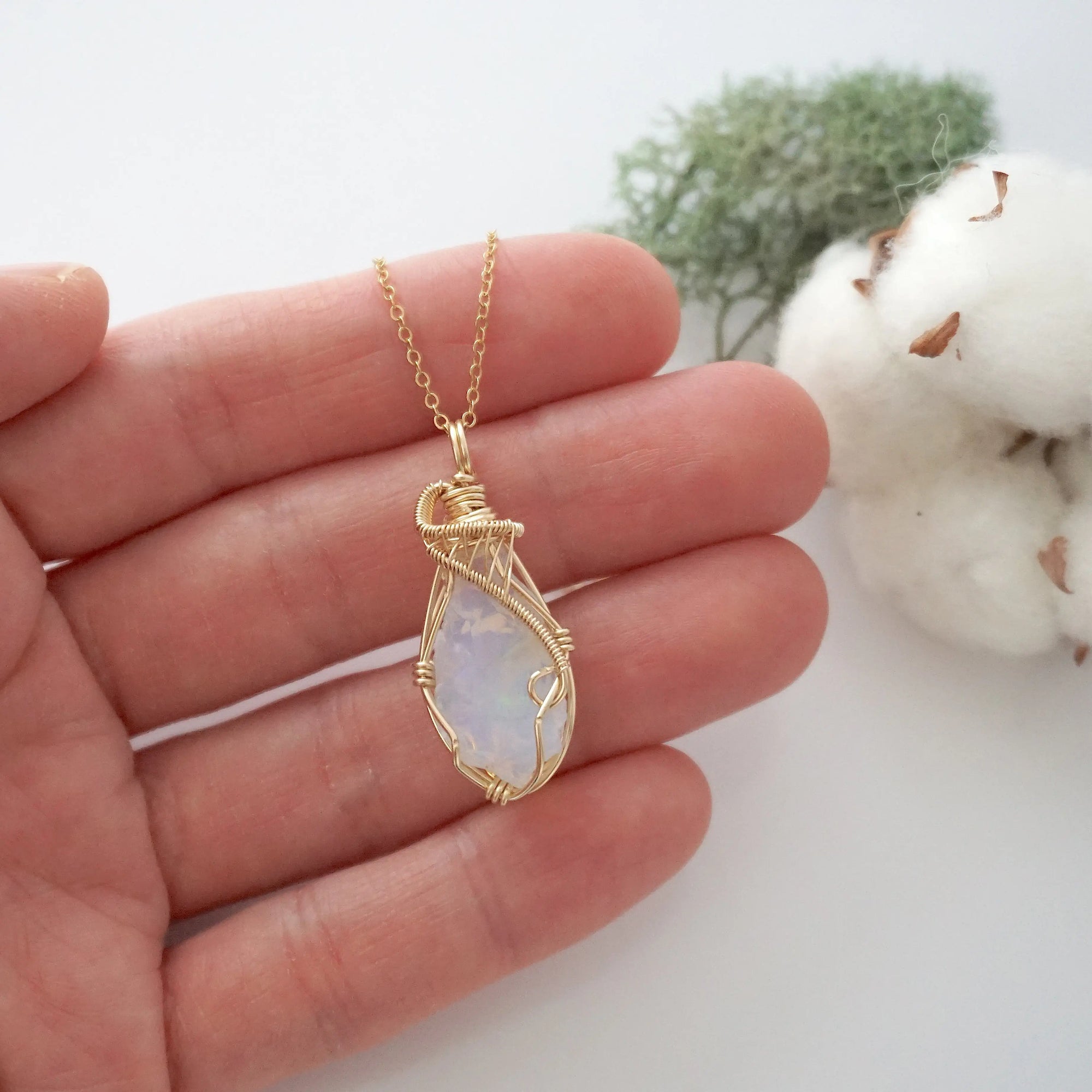 Raw opal necklace in 14k gold filled shown in hand for size reference. Artisan October birthstone pendant by Designs by Nature Gems.
