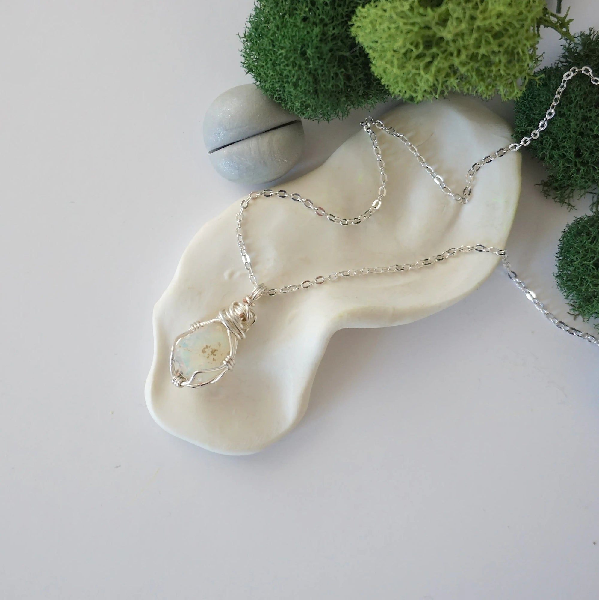 Simple raw opal necklace with silver plated brass chain laying flat