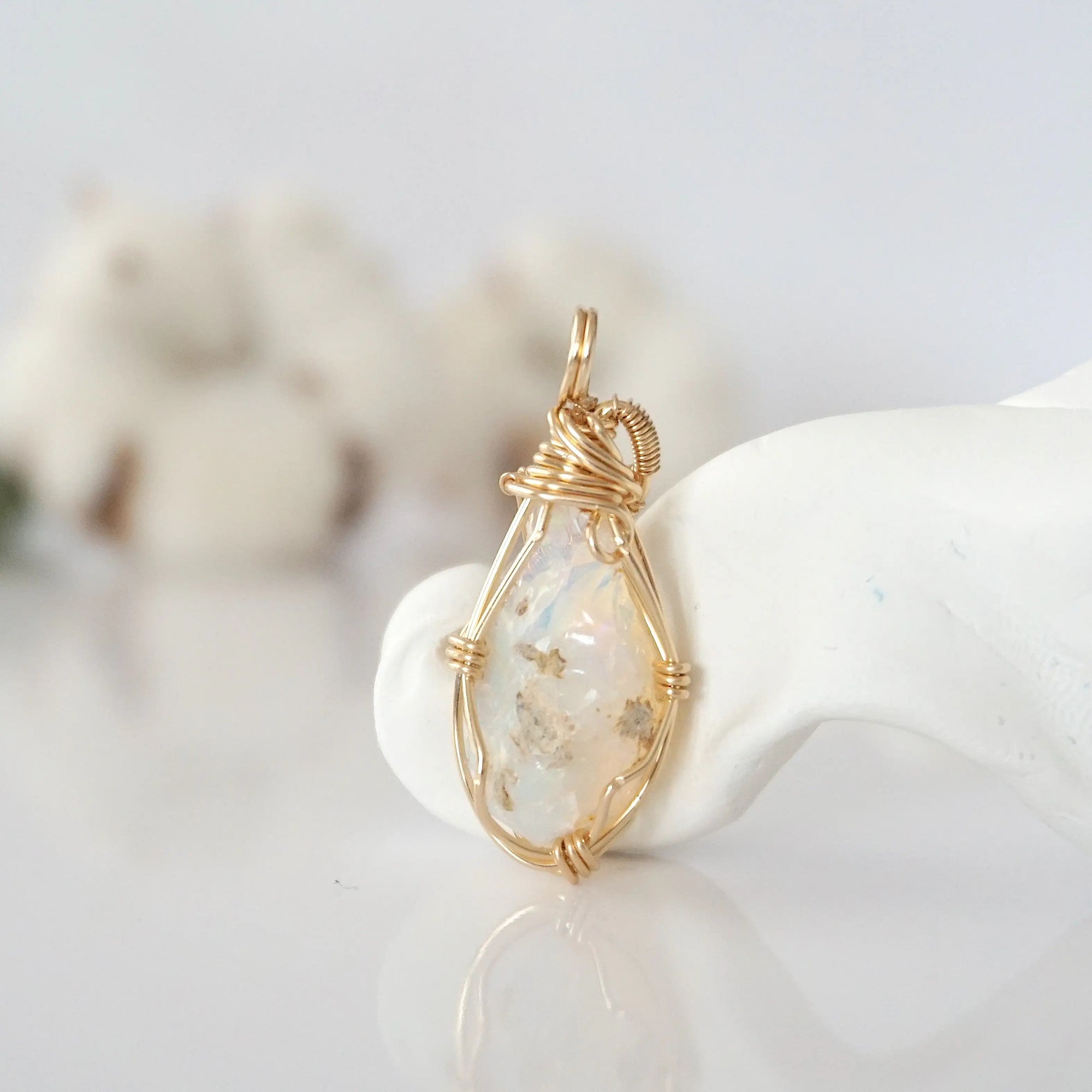 Back view of raw opal pendant in 14k gold filled, highlighting stone and wire detail. One of a kind October birthstone jewelry by Designs by Nature Gems.