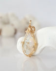 Back view of raw opal pendant in 14k gold filled, highlighting stone and wire detail. One of a kind October birthstone jewelry by Designs by Nature Gems.