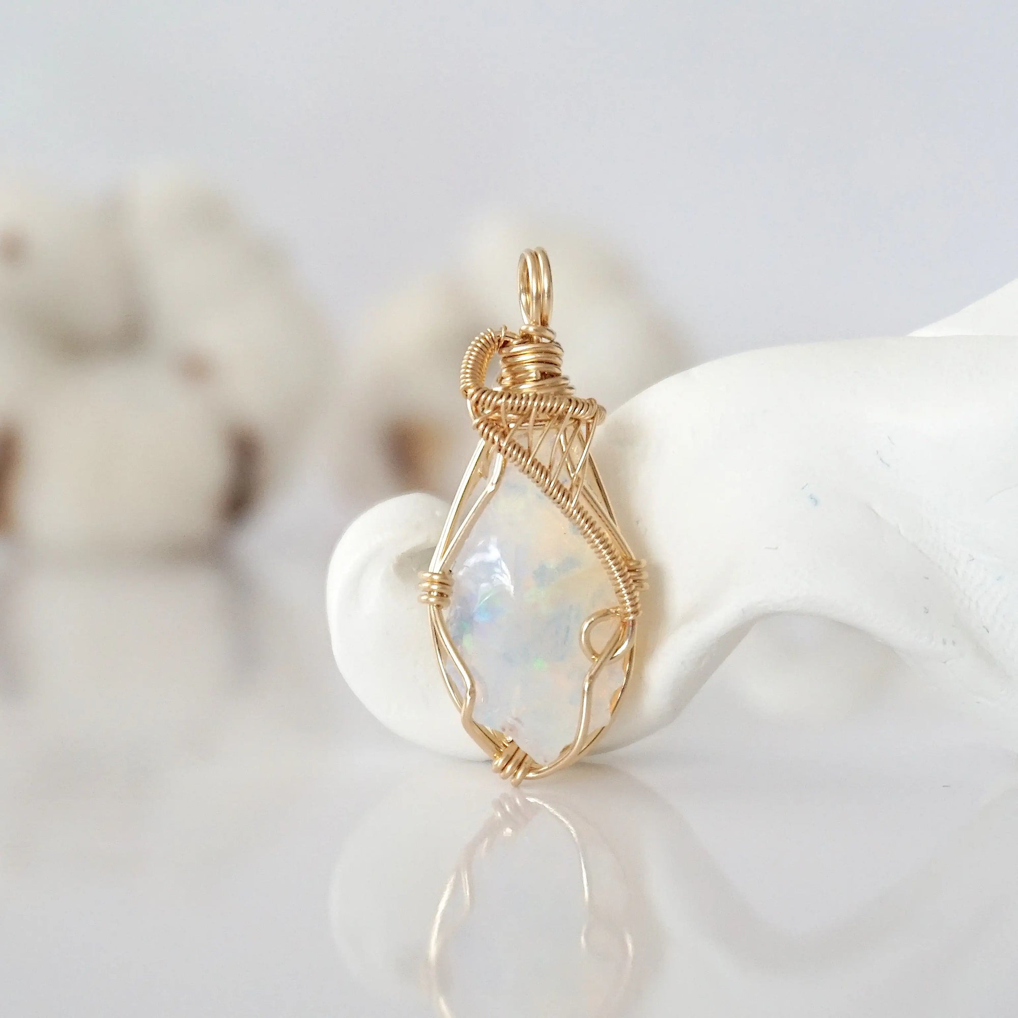 Detailed front view of raw opal pendant in 14k gold filled. Unique wire wrapped October birthstone jewelry by Designs by Nature Gems.
