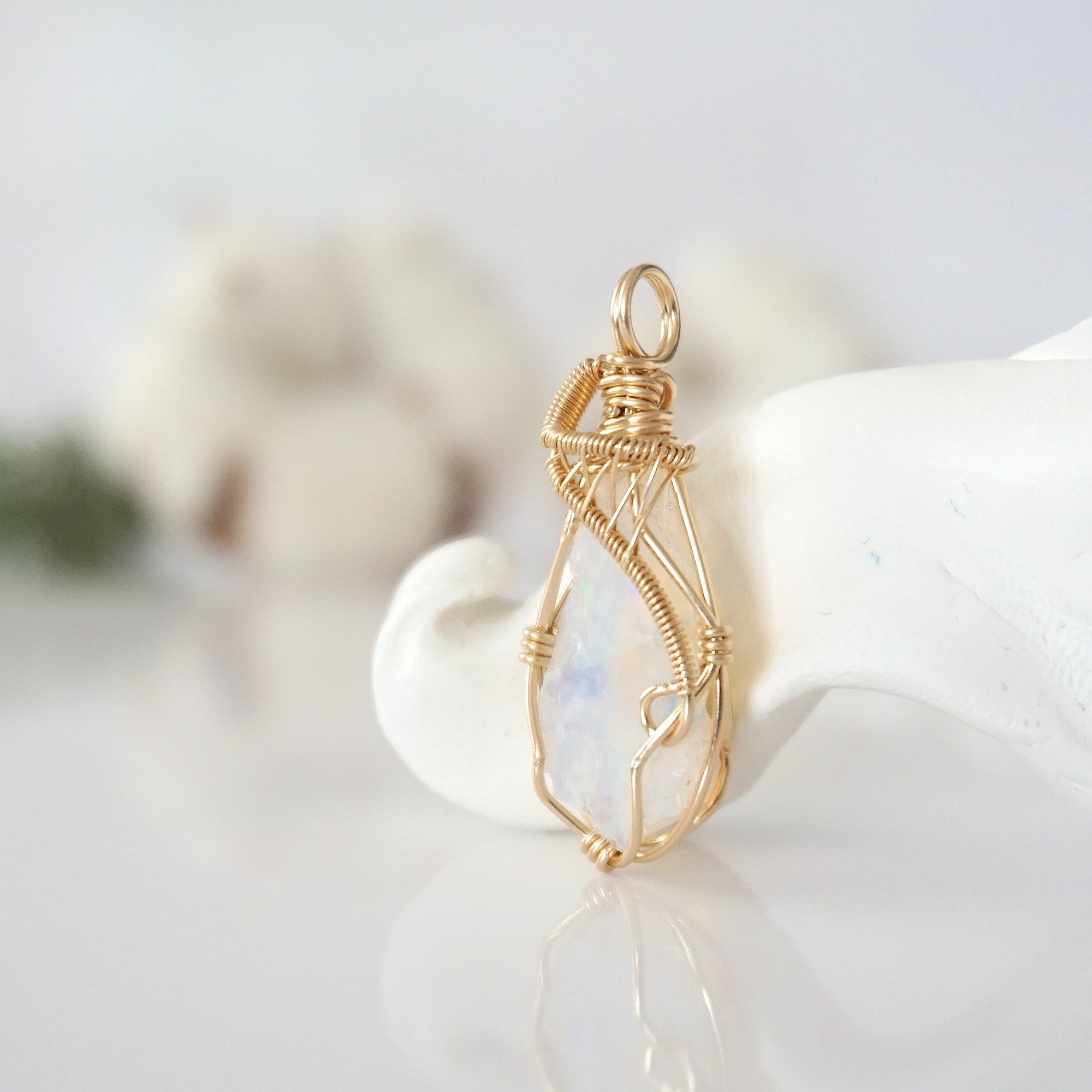 Side view of raw opal pendant in 14k gold filled, showing artisan wire wrapping. Handcrafted October birthstone necklace by Designs by Nature Gems.