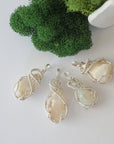 Four raw Ethiopian opal pendants showing natural variation in stone size, shape, and colour play — each one of a kind, October birthstone, 925 sterling silver wire wrapped, Designs by Nature Gems