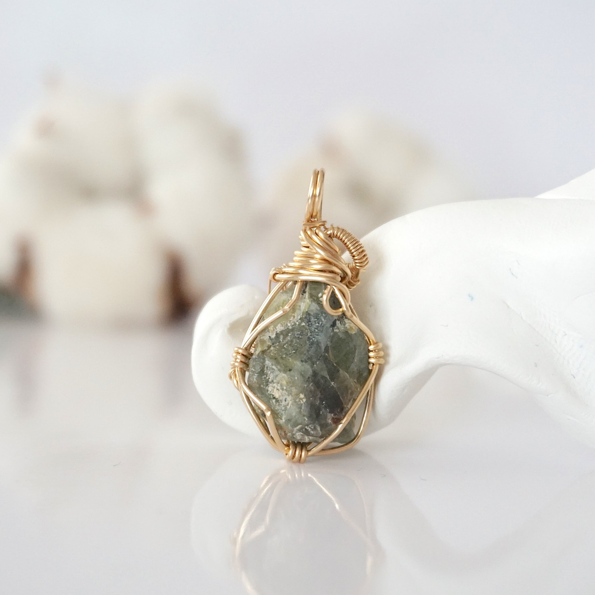 Back view of raw peridot pendant in 14k gold filled, highlighting stone and wire detail. One of a kind August birthstone jewelry by Designs by Nature Gems.