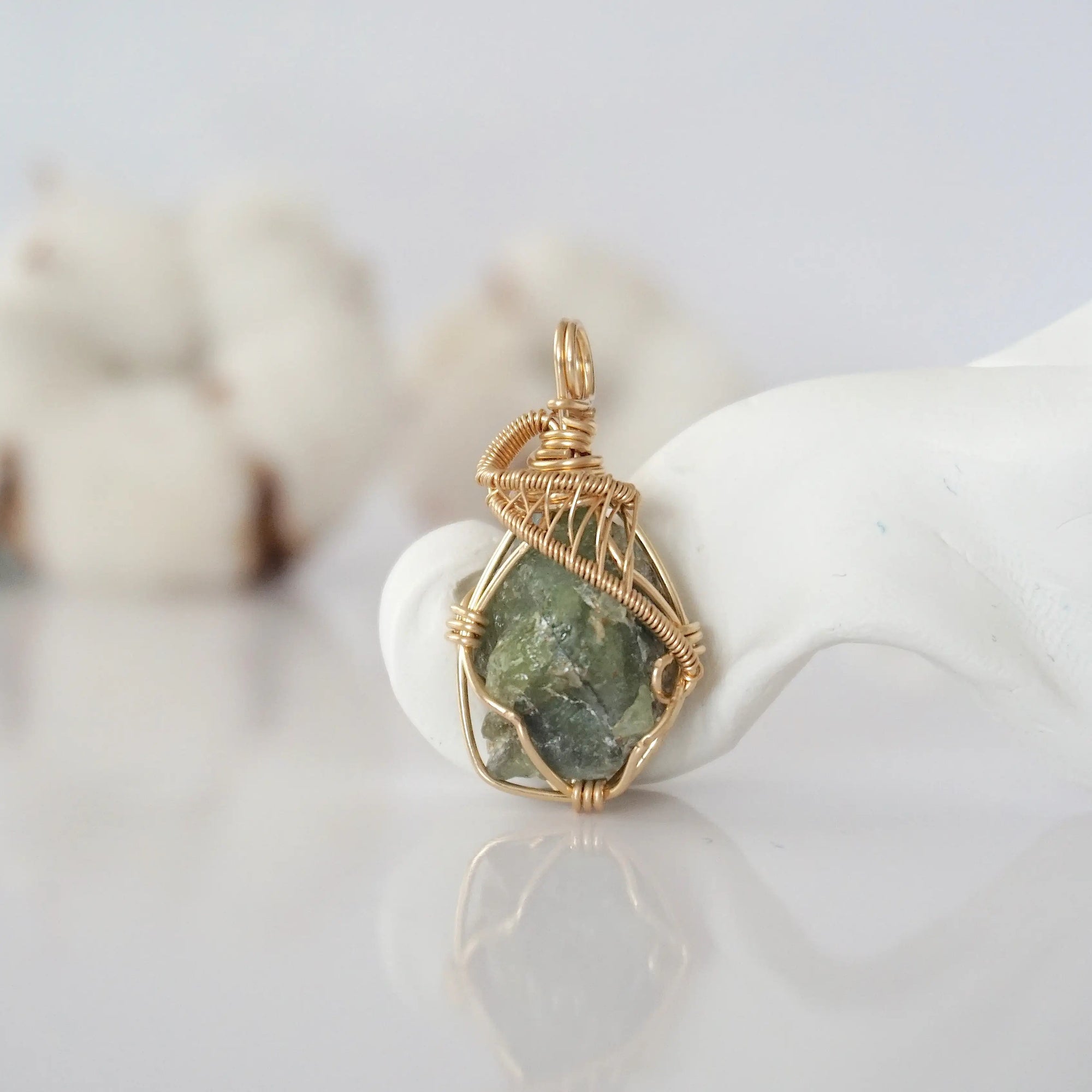 Detailed front view of raw peridot pendant in 14k gold filled. Unique wire wrapped August birthstone jewelry by Designs by Nature Gems.