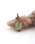 Front view of raw peridot pendant — natural olive green crystal wire wrapped in antique bronze, handcrafted August birthstone jewelry