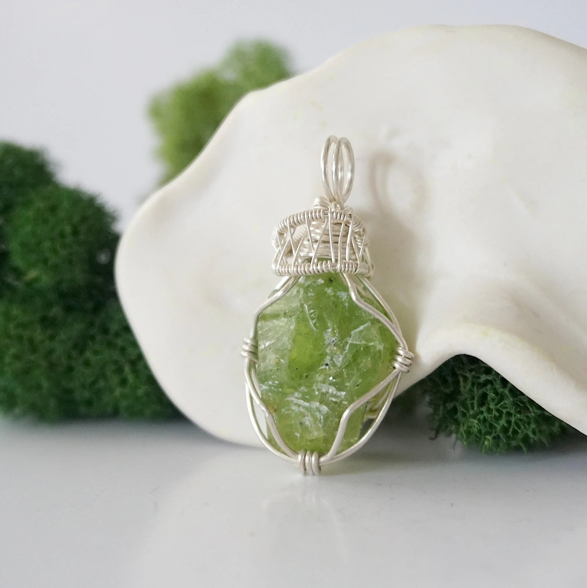 Left side detail of handmade raw peridot necklace — artisan wire wrapped 925 sterling silver pendant, natural peridot stone, ethically sourced crystal jewelry