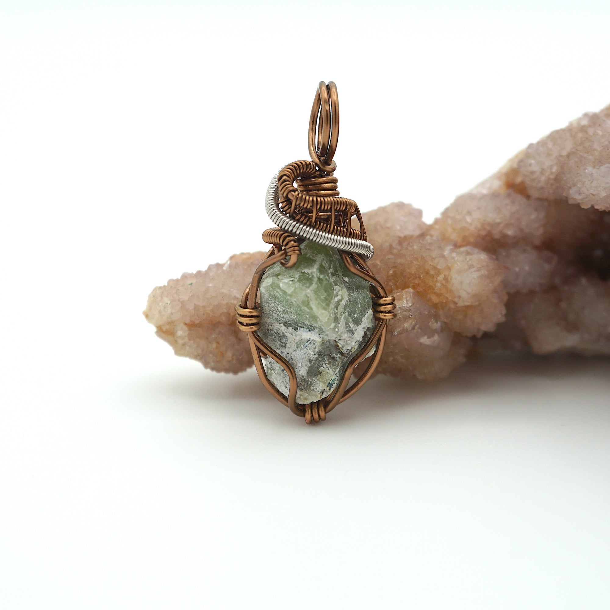 Front view of raw peridot pendant for women — soft sage olive green crystal with natural surface texture, antique bronze and dark silver wire wrap, handcrafted August birthstone jewelry