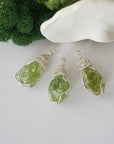 Three raw peridot pendants showing natural variation in stone size, shape, and green colour — each one of a kind, August birthstone, 925 sterling silver wire wrapped, Designs by Nature Gems