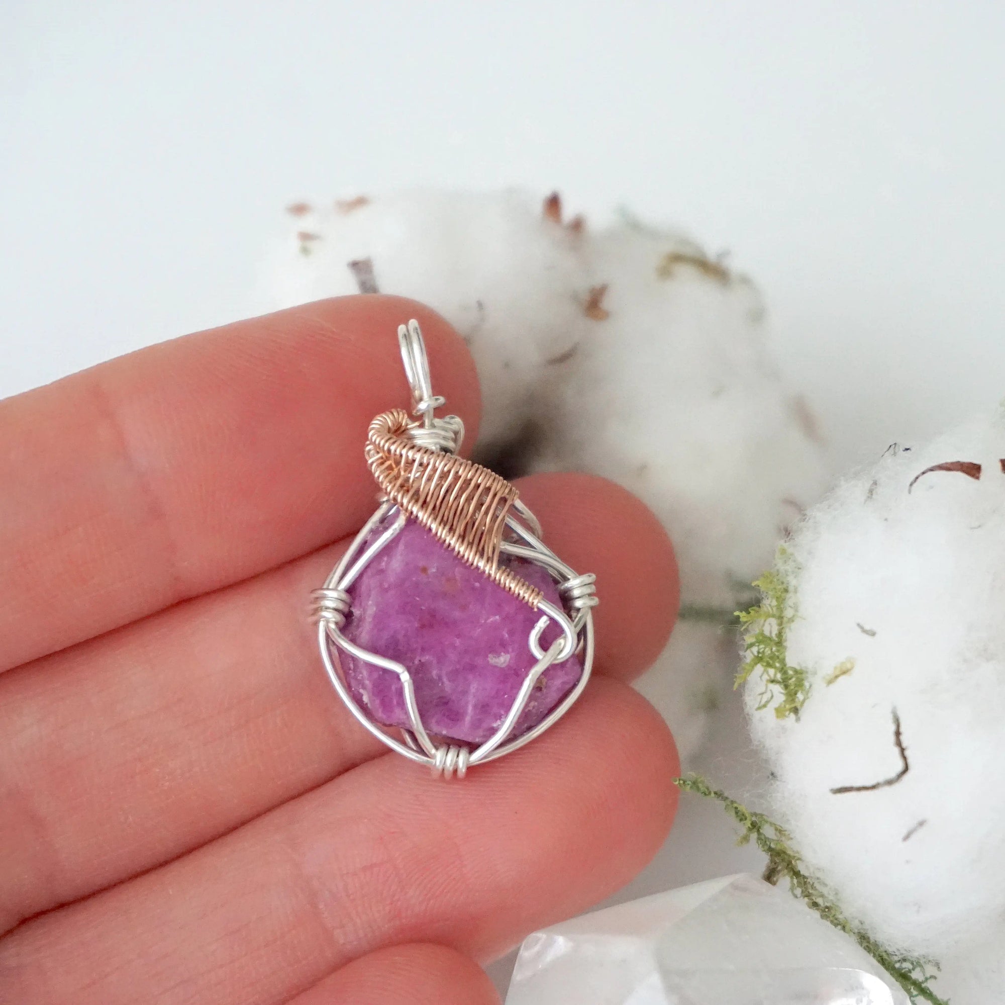 Raw pink ruby necklace in sterling silver and 14k rose gold filled shown in hand for size reference. Artisan July birthstone pendant by Designs by Nature Gems.