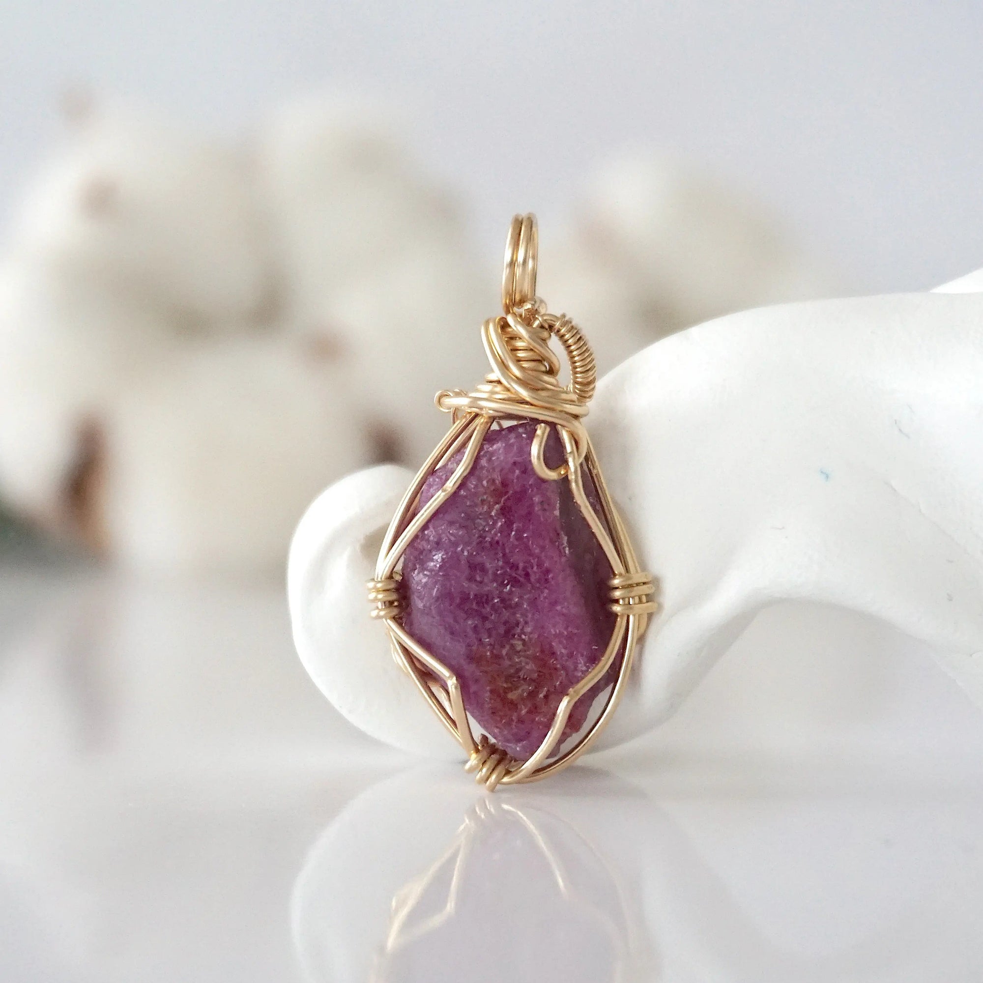 Back view of raw pink ruby pendant in 14k gold filled, highlighting stone and wire detail. One of a kind July birthstone jewelry by Designs by Nature Gems.