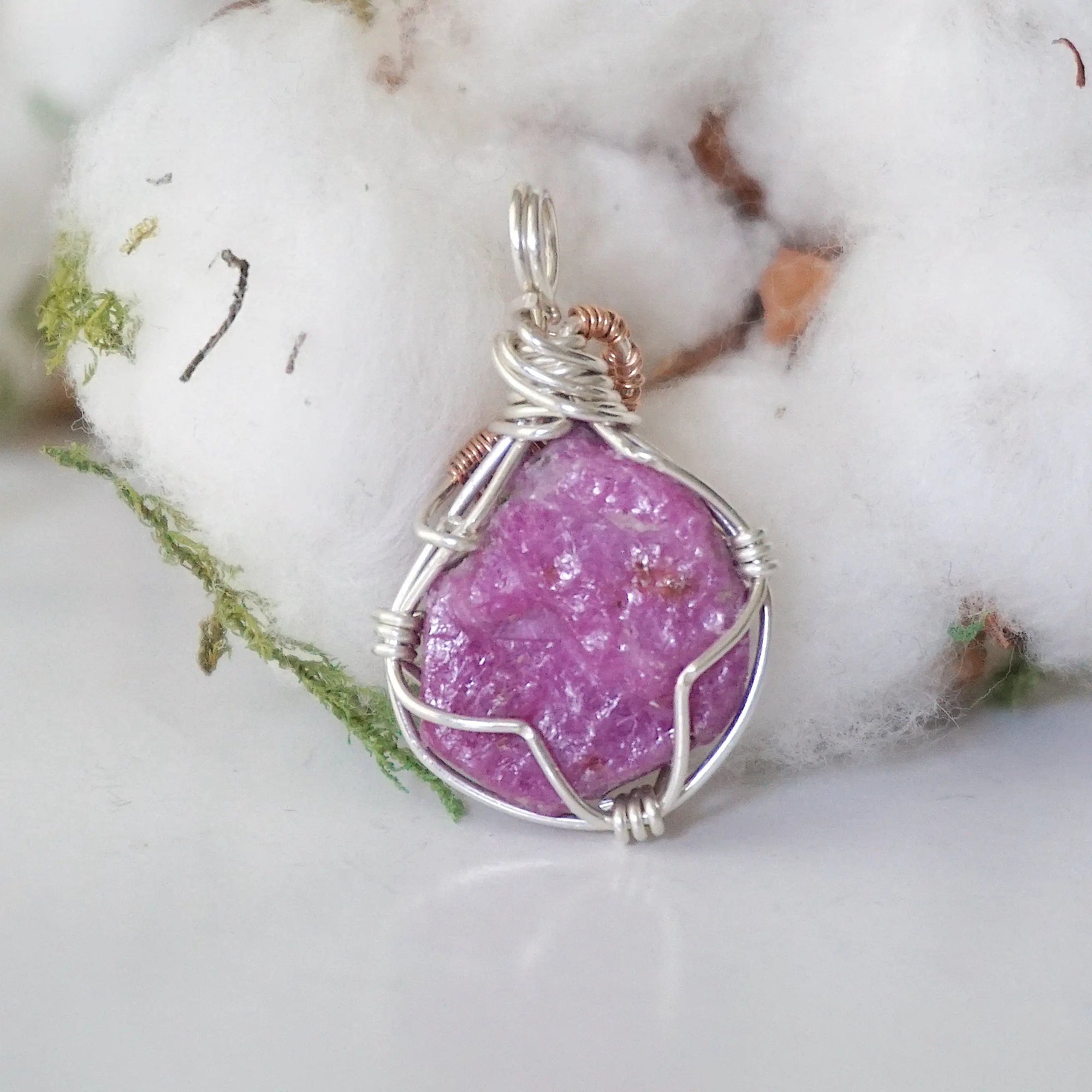 Back view of raw pink ruby pendant in sterling silver and 14k rose gold filled, highlighting stone and wire detail. One of a kind July birthstone jewelry by Designs by Nature Gems.