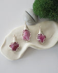 Three different raw pink ruby pendants displayed for variation reference