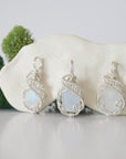 Three raw rainbow moonstone necklaces showing natural crystal variations and blue flash in handmade wire wrapped pendants