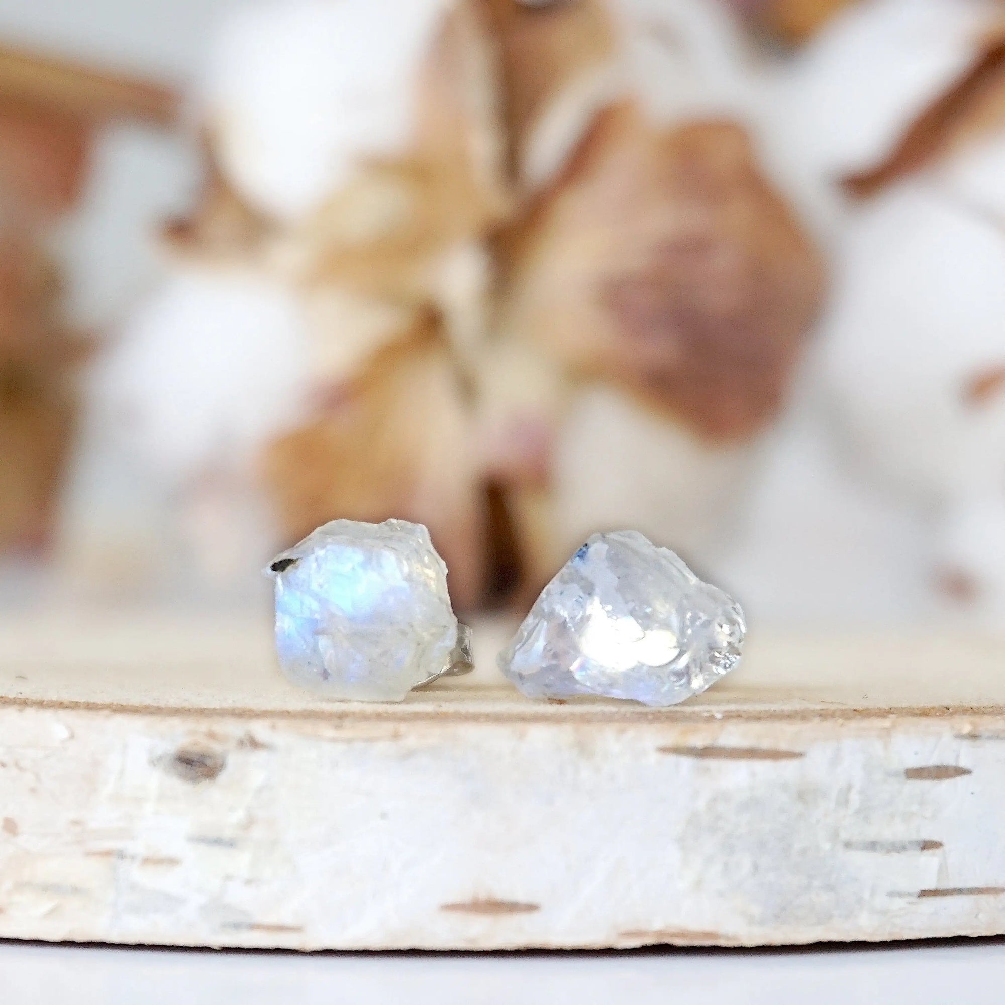 Front view close-up of raw rainbow moonstone stud earrings featuring natural uncut moonstone stones on 925 sterling silver posts.