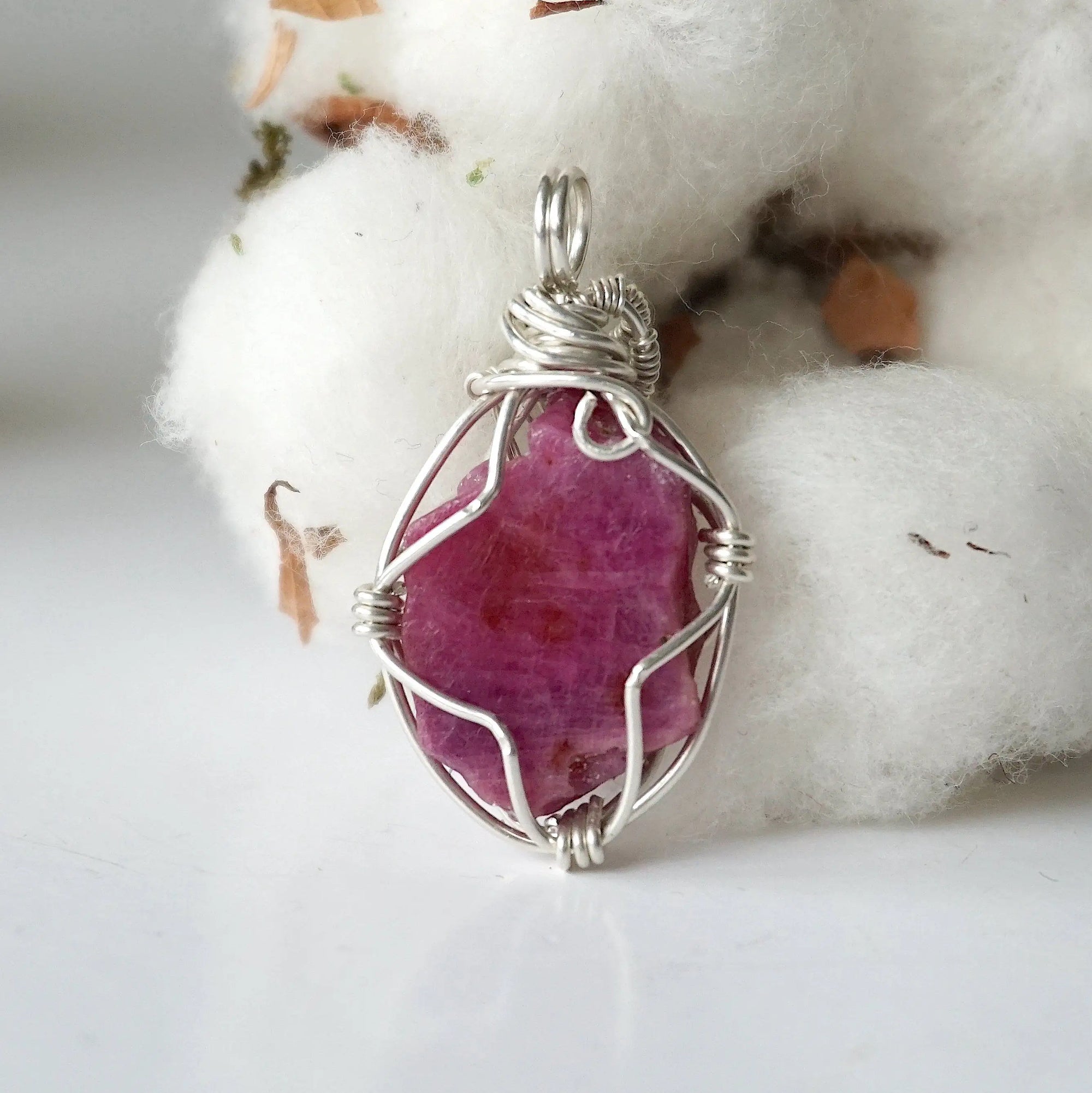 Back side angle of raw ruby pendant, natural pink ruby, sterling silver artisan wire wrapping