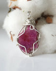 Back side angle of raw ruby pendant, natural pink ruby, sterling silver artisan wire wrapping