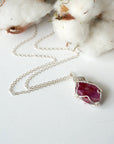 Raw ruby necklace for women on sterling silver chain, laying flat, natural pink ruby pendant, artisan wire wrapped