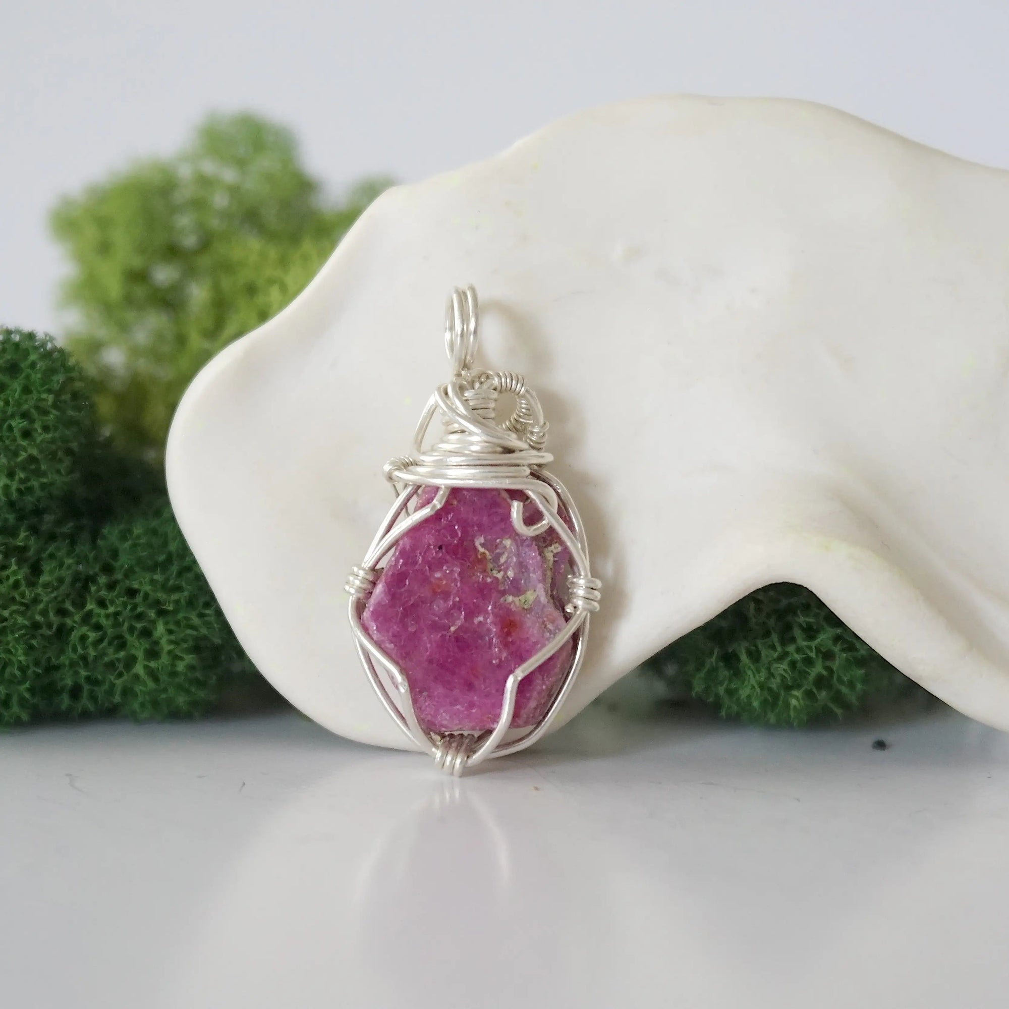 Back view of raw ruby wire wrapped pendant — 925 sterling silver hand-wrapped setting, shows craftsmanship and secure stone hold, handmade in Toronto Canada
