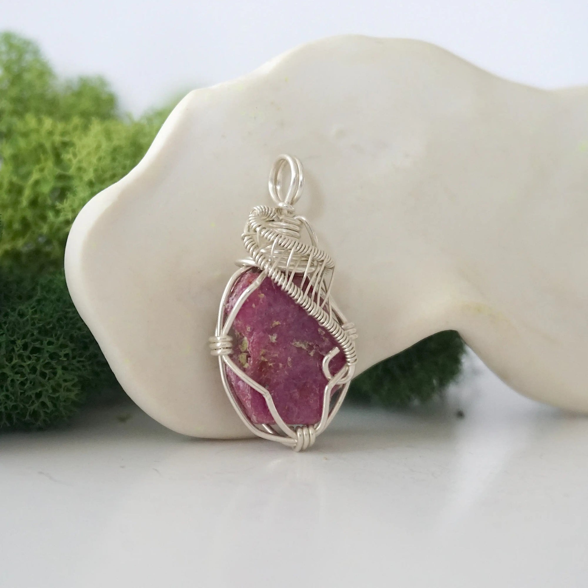 Right side detail of raw ruby crystal pendant — intricate 925 sterling silver wire weaving technique, handcrafted artisan wire wrapped jewelry, Designs by Nature Gems