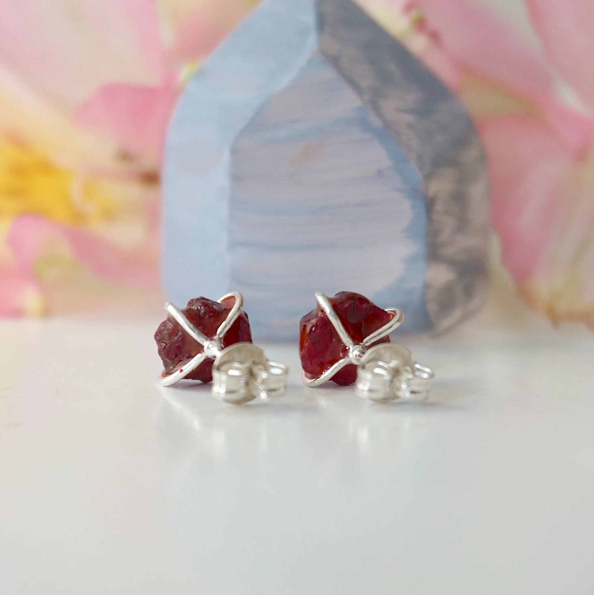 Back view of raw ruby prong stud earrings showing 925 sterling silver posts and butterfly closure — natural crystal earrings quality detail