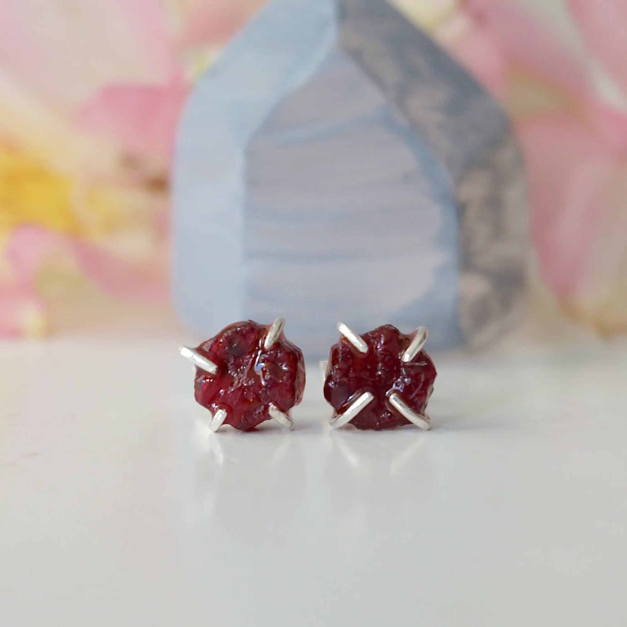 Front view of raw ruby prong stud earrings showing open claw 925 sterling silver setting — minimalist natural crystal earrings for women