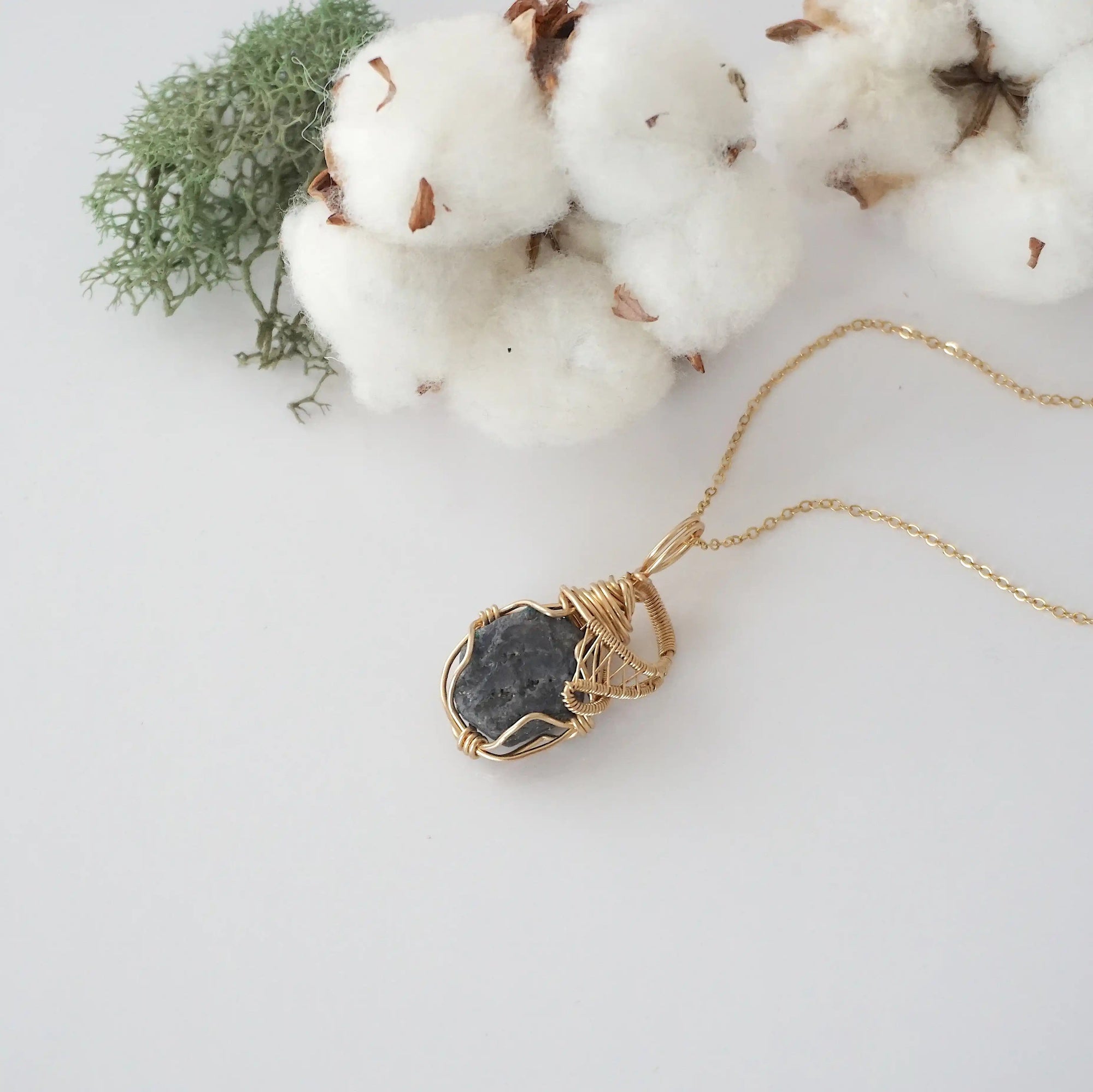 Raw sapphire necklace in 14k gold filled laying flat. Handcrafted September birthstone jewelry for women by Designs by Nature Gems.