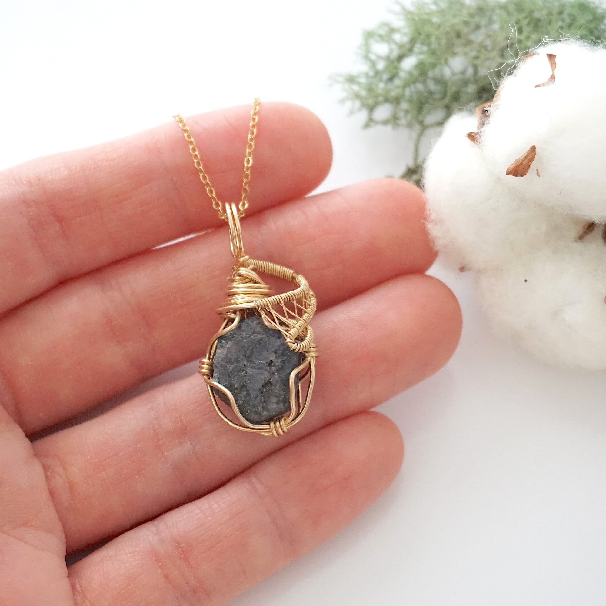 Raw sapphire necklace in 14k gold filled shown in hand for size reference. Artisan September birthstone pendant by Designs by Nature Gems.