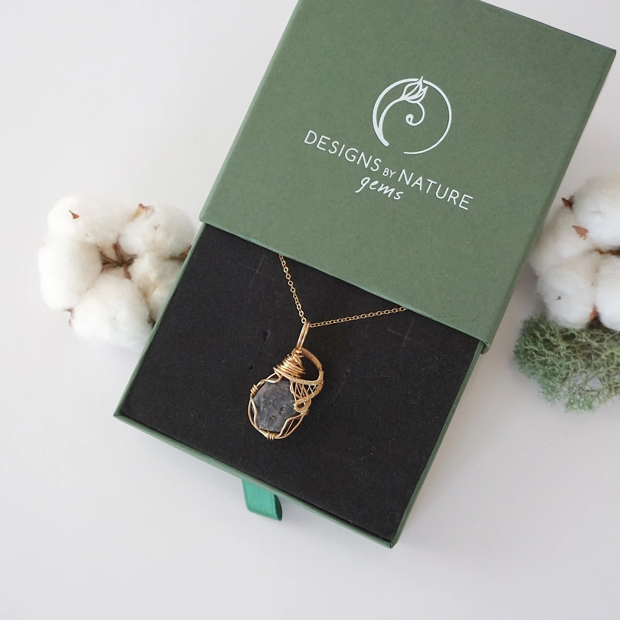 Raw sapphire necklace in 14k gold filled displayed in branded Designs by Nature Gems jewelry box. Artisan September birthstone gift for women.