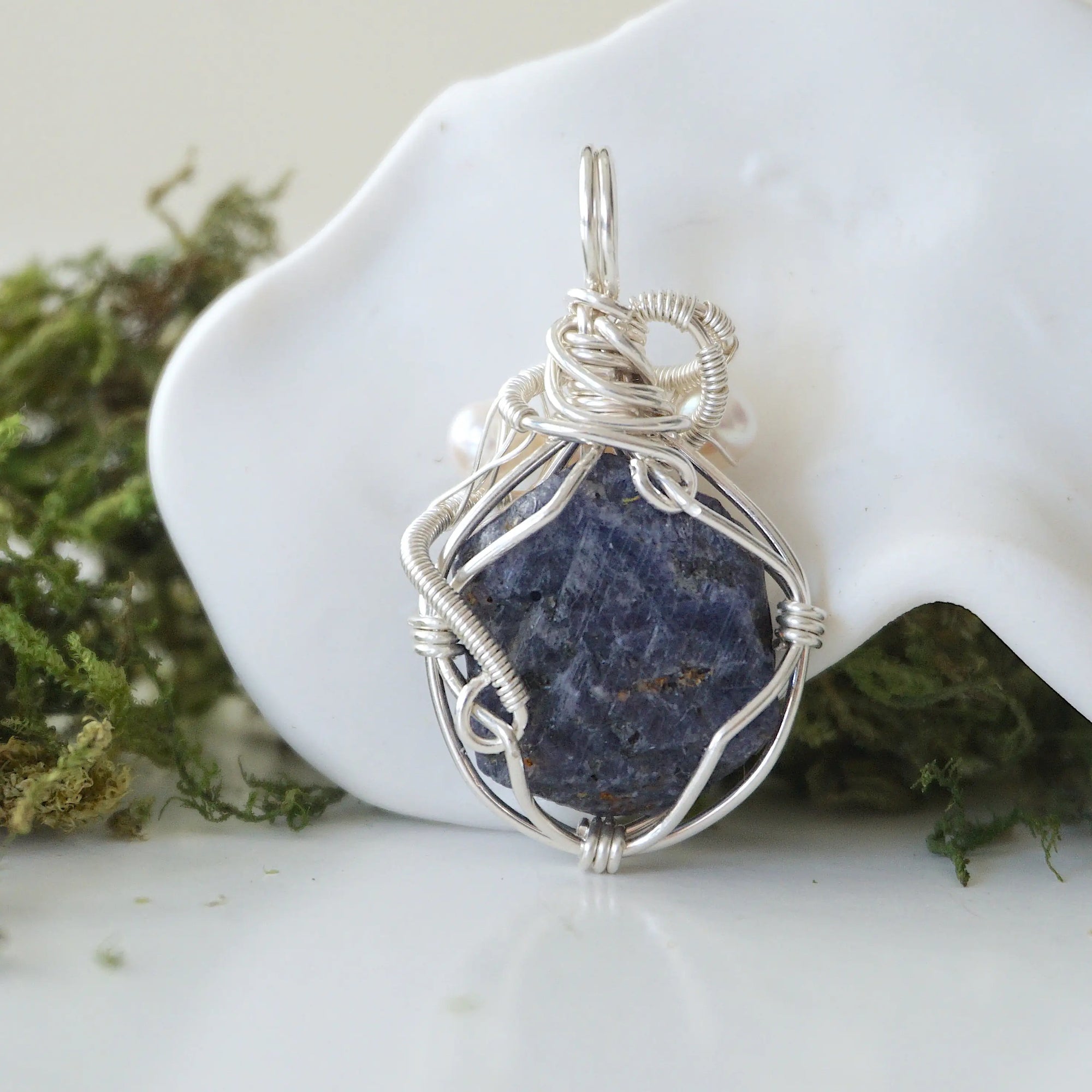 Back view of raw sapphire and freshwater pearl pendant showing the detail of 925 sterling silver wire-wrapping — one-of-a-kind handcrafted crystal jewelry