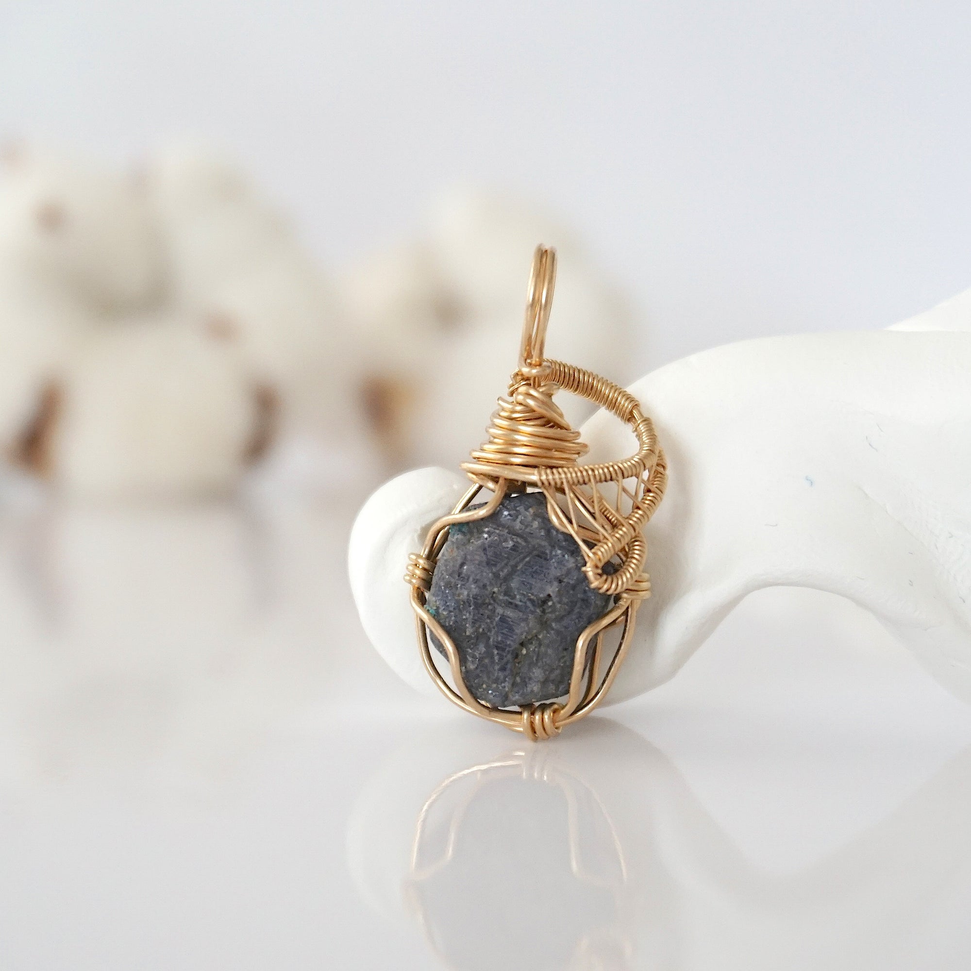 Detailed front view of raw sapphire pendant in 14k gold filled. Unique wire wrapped September birthstone jewelry by Designs by Nature Gems.