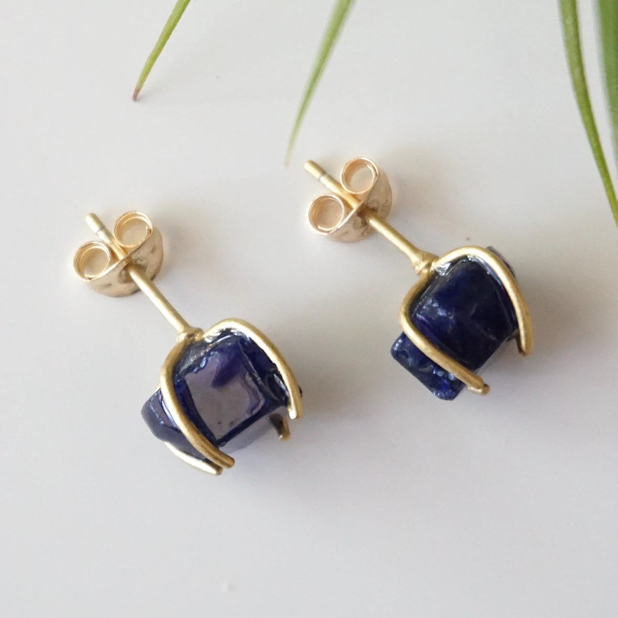 Back view of raw sapphire stud earrings showing the 14k gold vermeil posts and butterfly closures